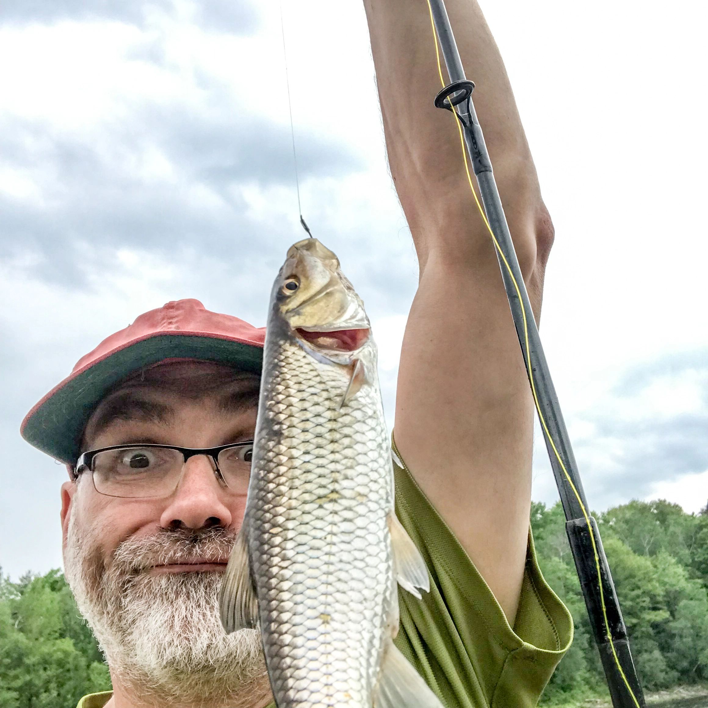Portrait of an angler outdoors holding a fishing rod