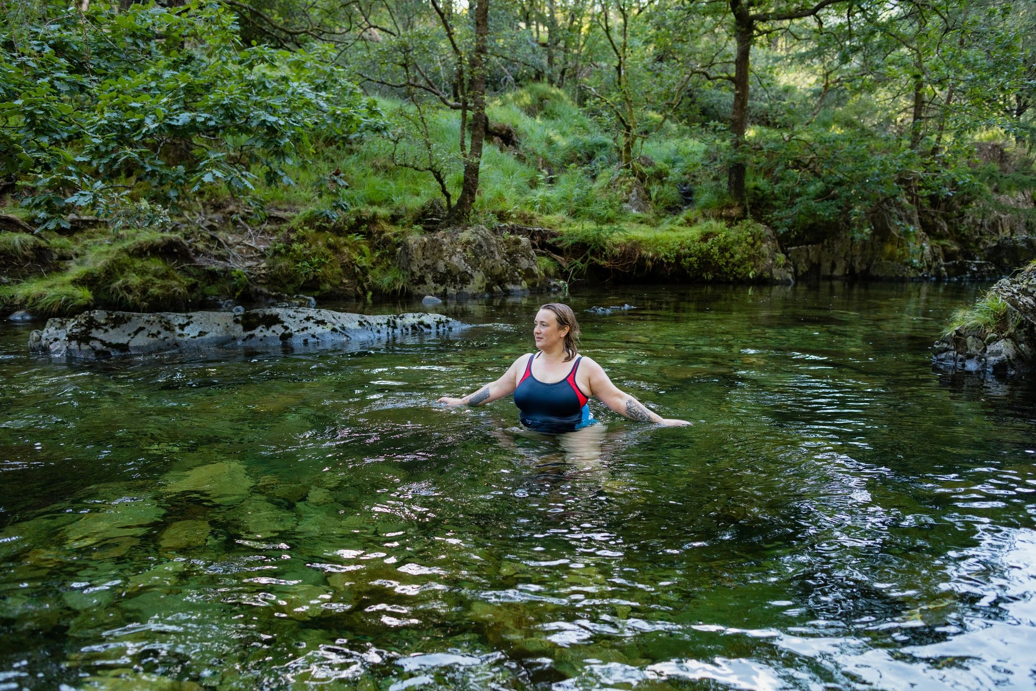 Lady wading through a river