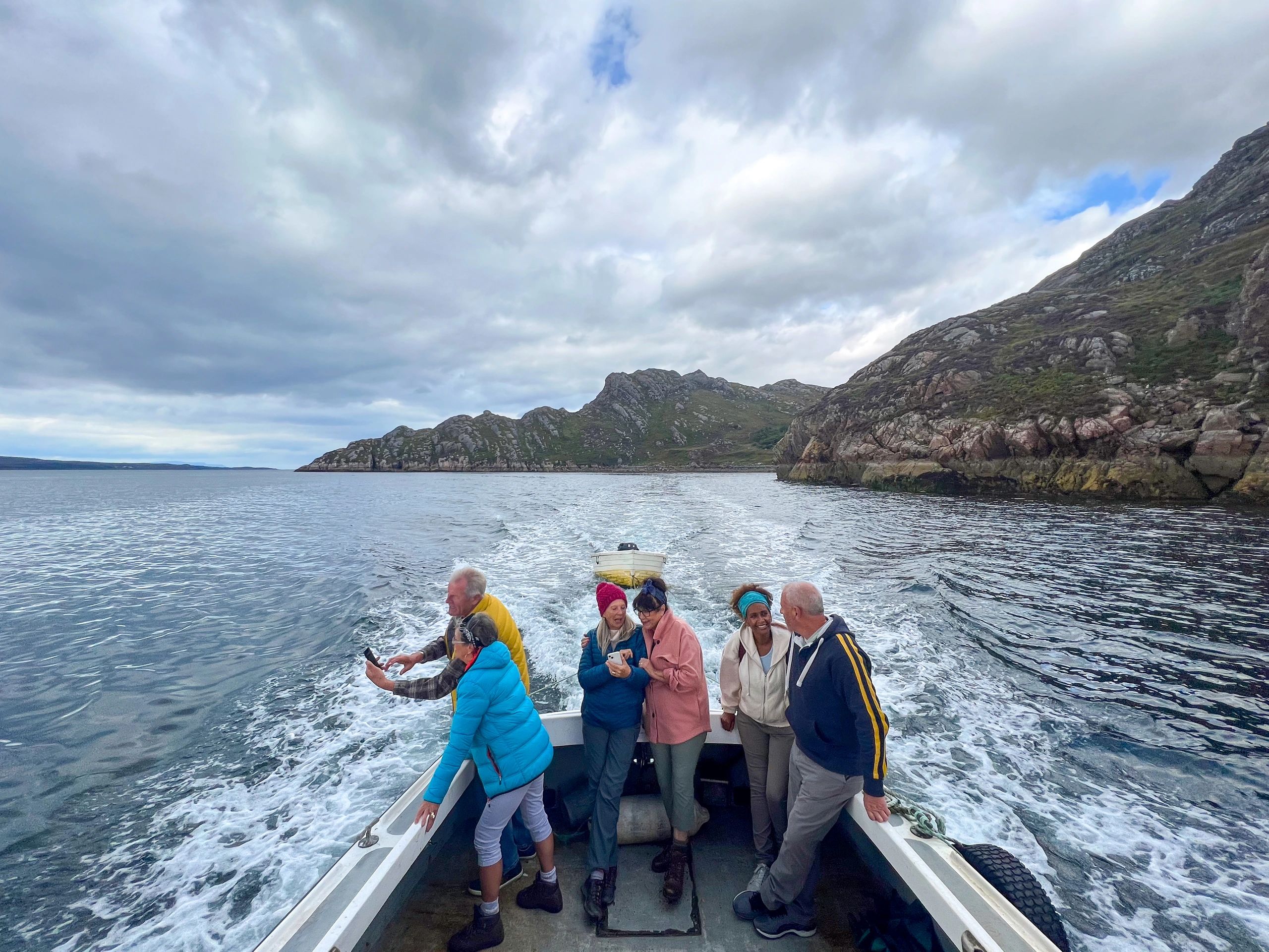Friends on a boat enjoying an offshore trip on open water