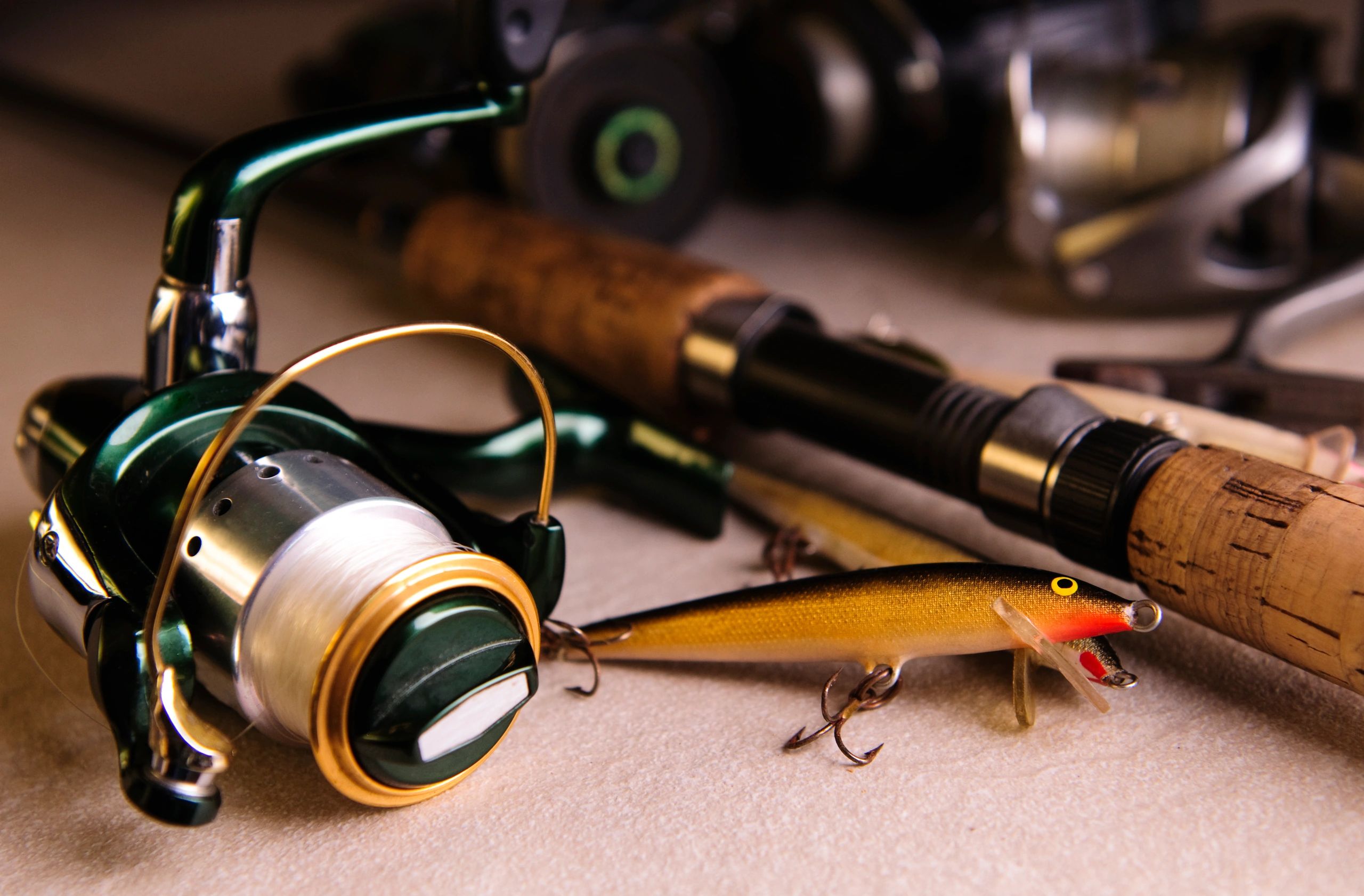 Close-up of fishing tackle including lures, hooks, and reel