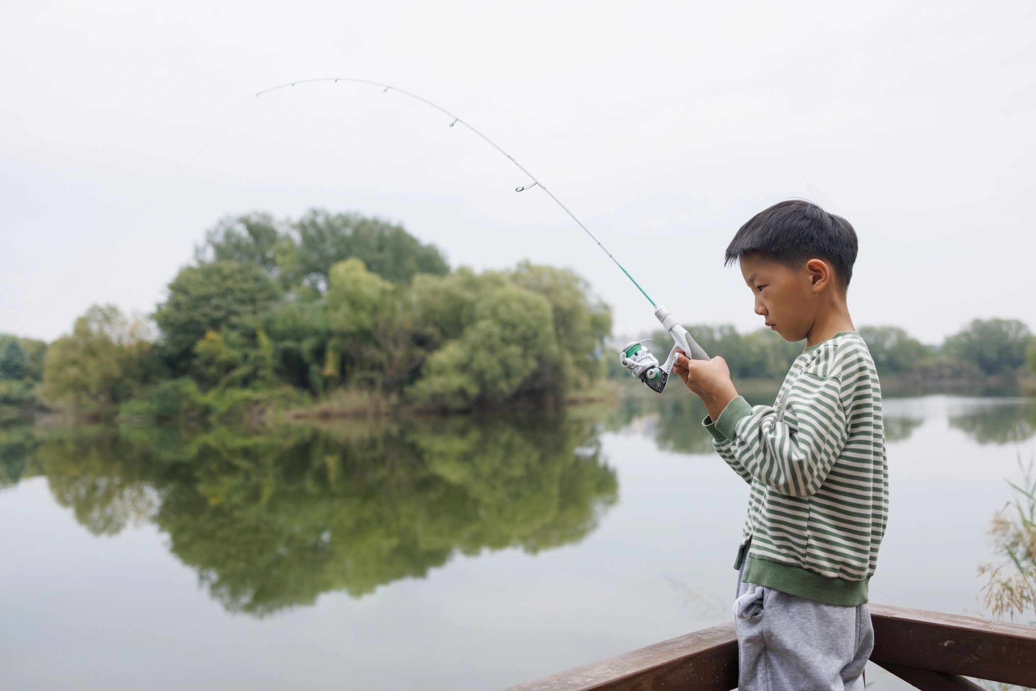 Angler fly fishing by a lake