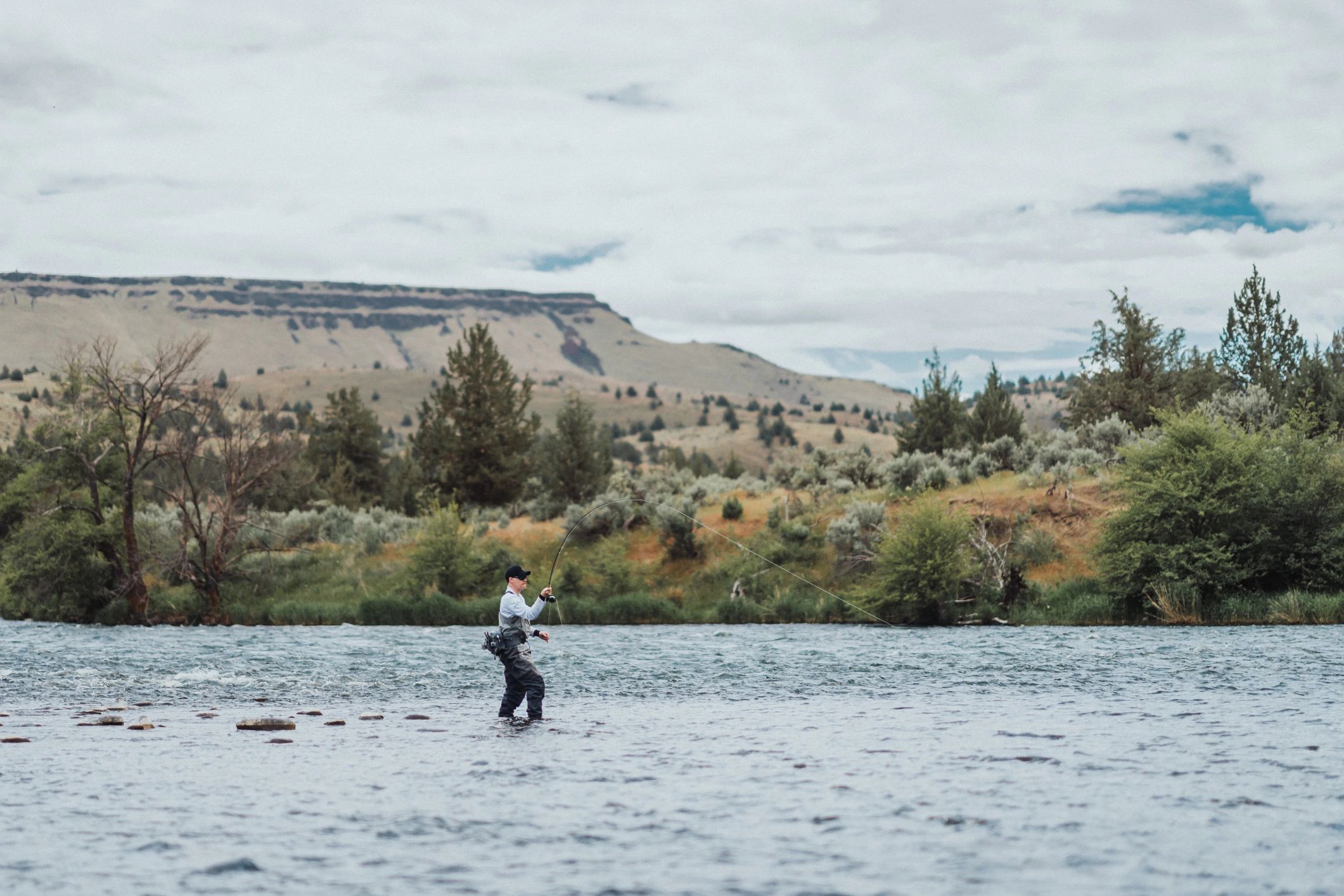 Fly angler wading in a river